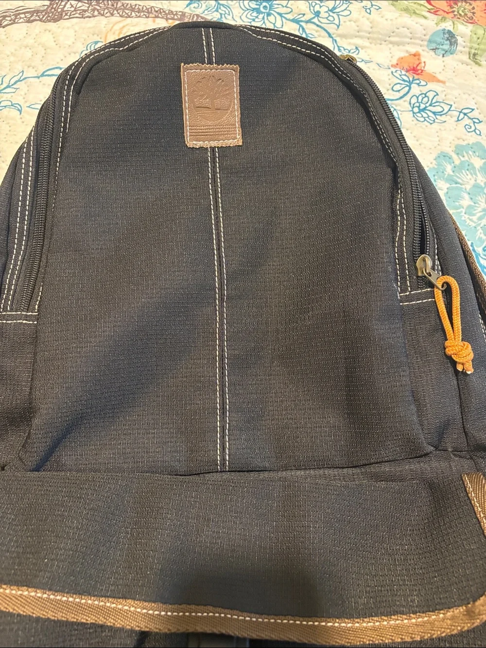 Timberland Black Canvas Backpack with Brown Trim and Orange Pull